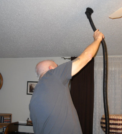 David vacuuming ceiling